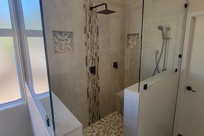 Custom design doorless walk-in shower with rain shower head and two shower niches